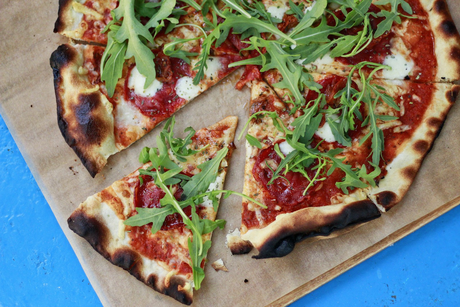 A rustic wood-fired pizza with a blistered, golden crust